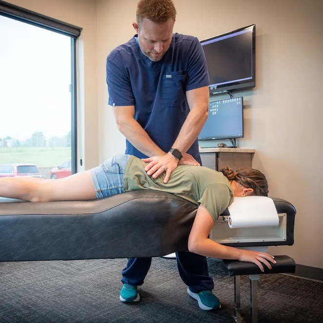 Chiropractor Dr. Nick Heiss Performing Chiropractic Adjustment on Patient in South Lincoln, NE.
