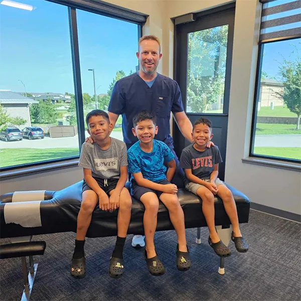 Pediatric Chiropractor Dr. Nick Heiss With Pediatric Patients in South Lincoln, NE.